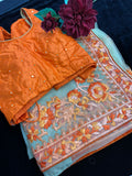 Beige Net  Saree with threadwork and orange Stitched Blouse