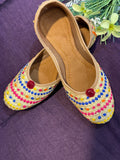 Gold Multicolor Embroidered Punjabi Jutti – Handcrafted Ethnic Footwear with Vibrant Threadwork & Pom-Pom Detailing