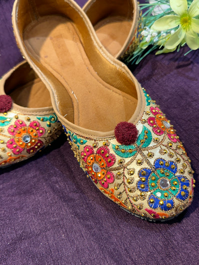 Gold Multicolor Phulkari Embroidered Punjabi Jutti – Handcrafted Ethnic Footwear with Mirror Work & Pom-Pom Detailing