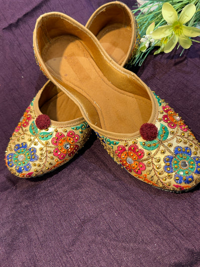 Gold Multicolor Phulkari Embroidered Punjabi Jutti – Handcrafted Ethnic Footwear with Mirror Work & Pom-Pom Detailing