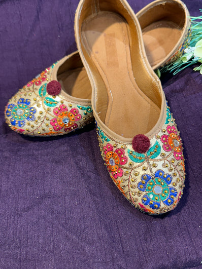 Gold Multicolor Phulkari Embroidered Punjabi Jutti – Handcrafted Ethnic Footwear with Mirror Work & Pom-Pom Detailing